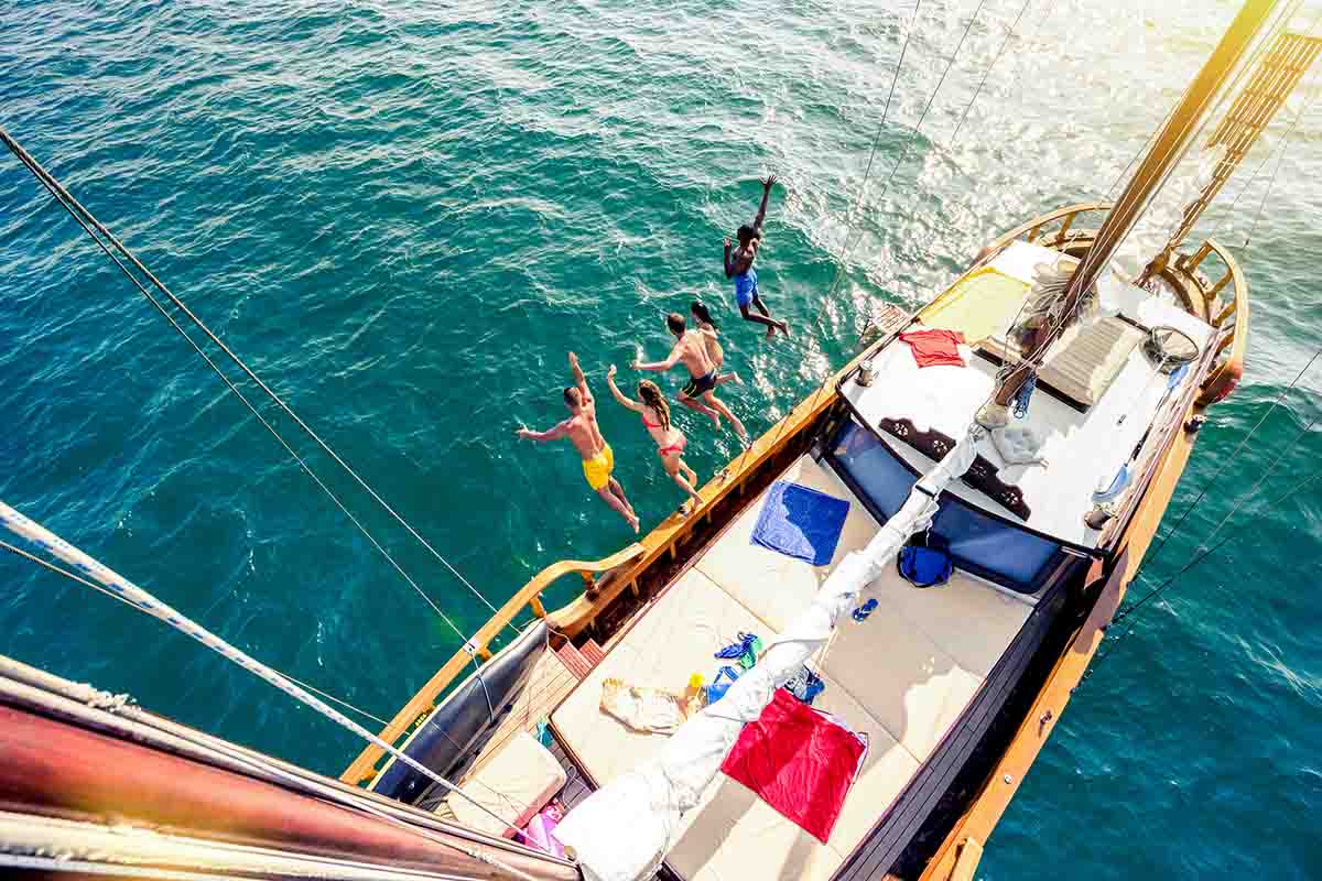 aerial view of young people enjoying a sailboat adventure